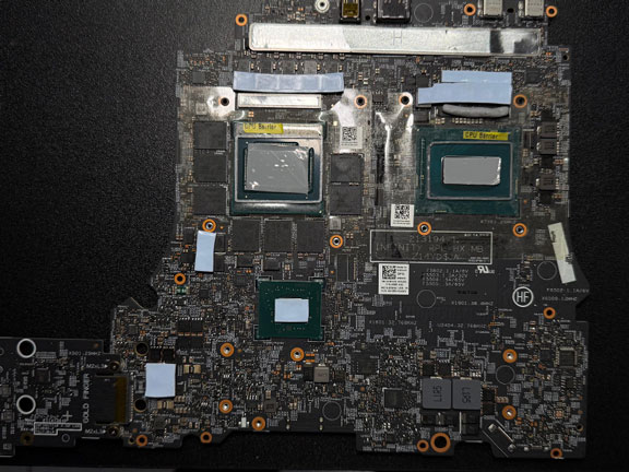Gaming laptop motherboard with thermal paste applied to CPU and GPU chips